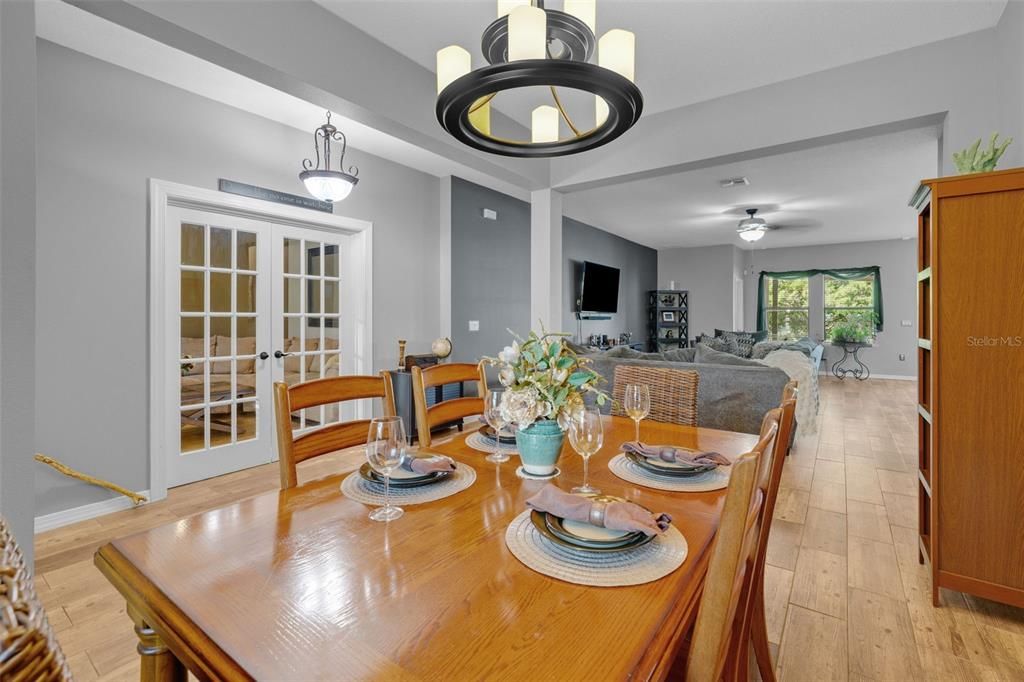 Formal dining area with private den, flexible space through double doors on the left