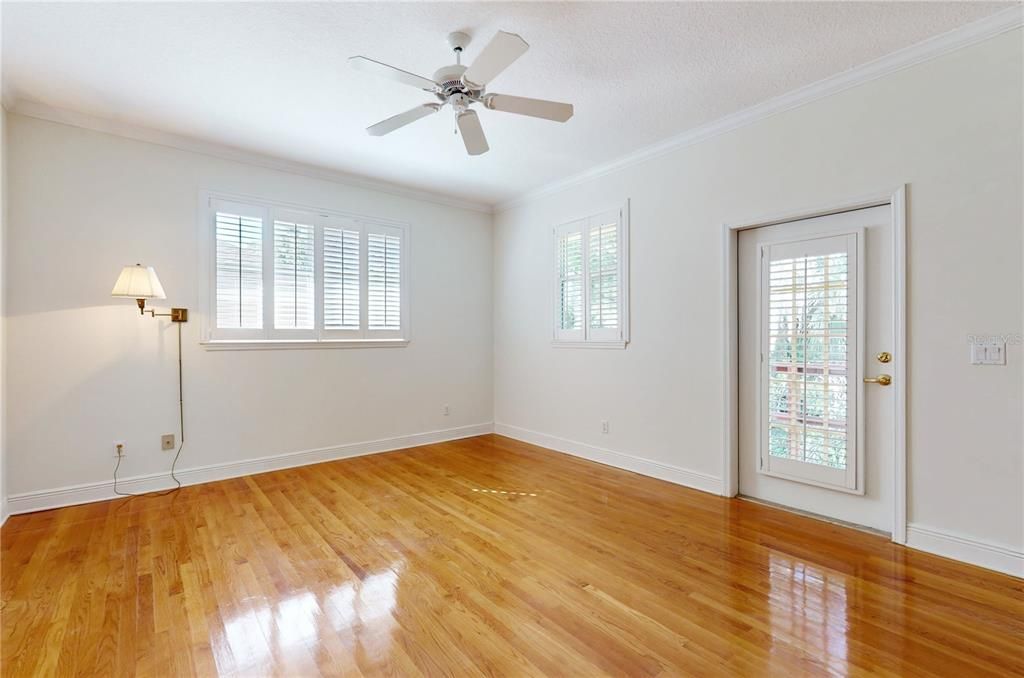 PRIMARY BEDROOM WITH ACCESS TO DECK AND CREEK VIEW.