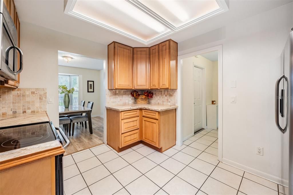 Open Kitchen with Stainless Steel Appliances, Tile countertops and tile flooring.