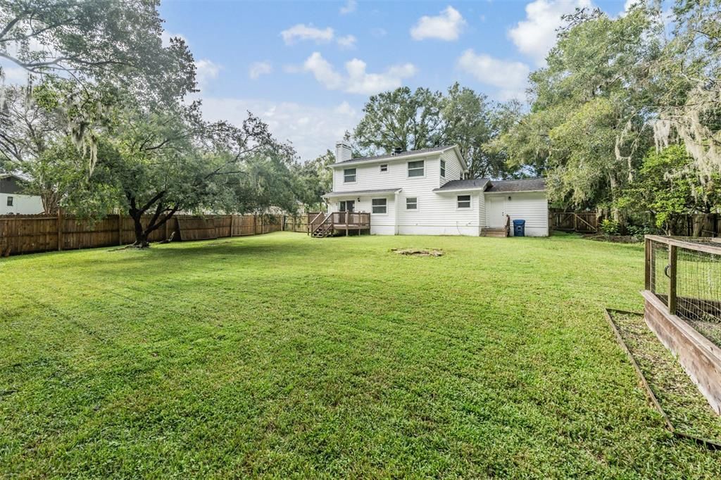 Huge fenced in backyard with a decki.