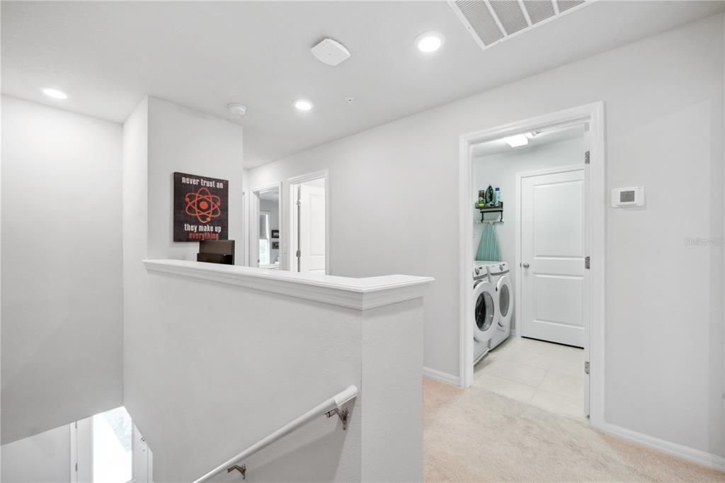 Spacious laundry room upstairs near primary bedroom with washer/dryer included