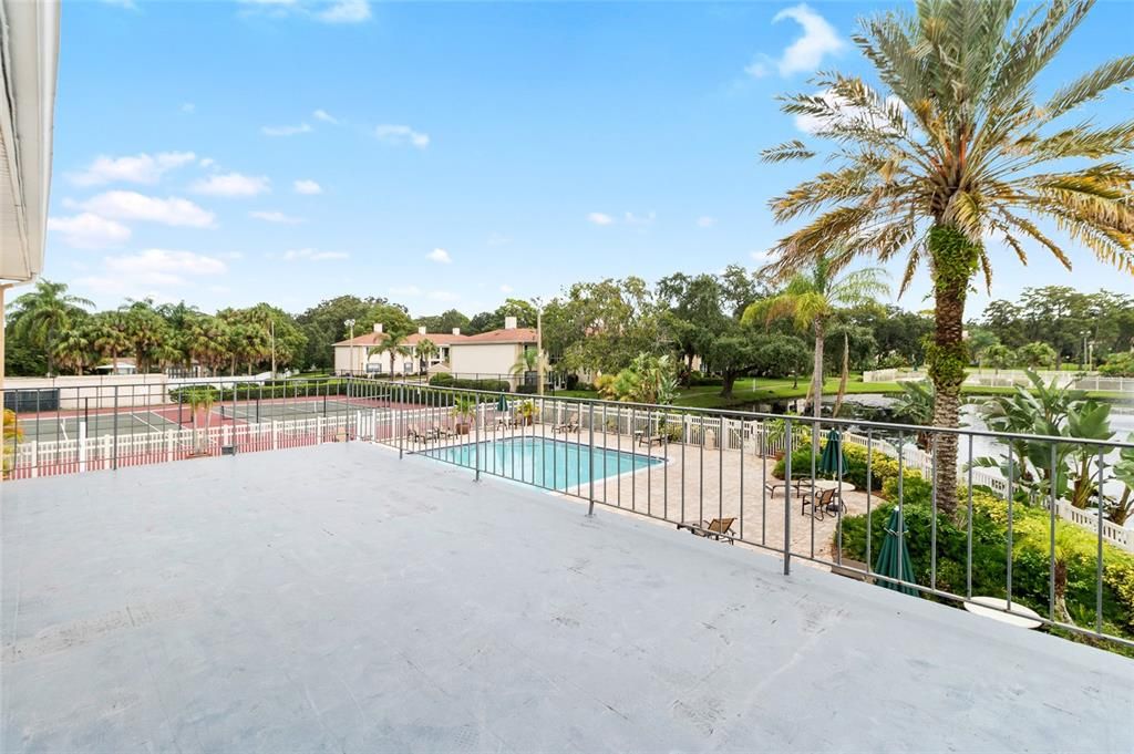 Patio in clubhouse overlooking pools and tennis