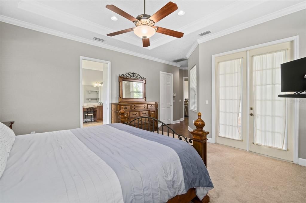 Primary bedroom with French doors to the covered patio