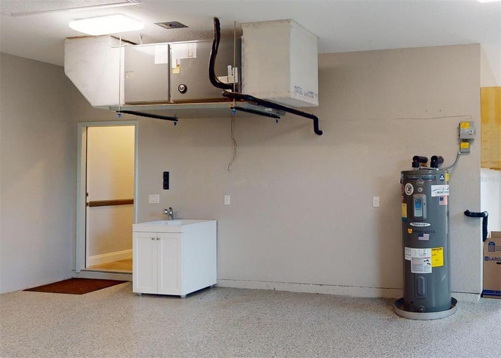 Oversized garage with utility sink and epoxy flooring