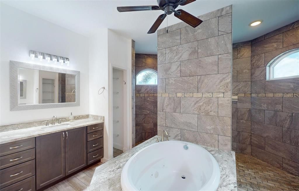 Jacuzzi jetted tub and large walk around Roman shower