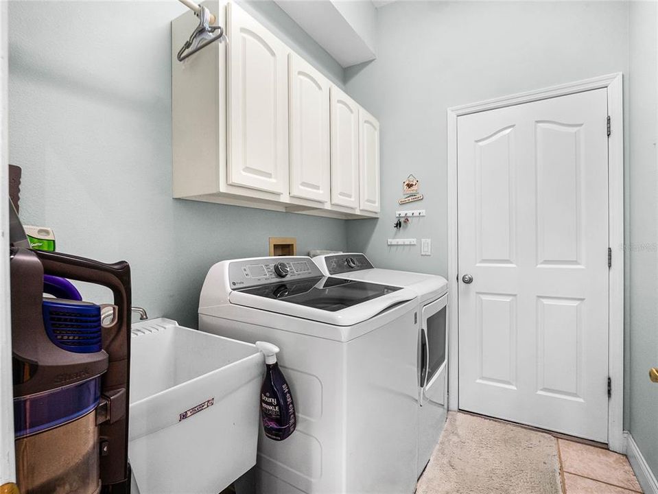 Laundry complete with cabinets and utility sink too !