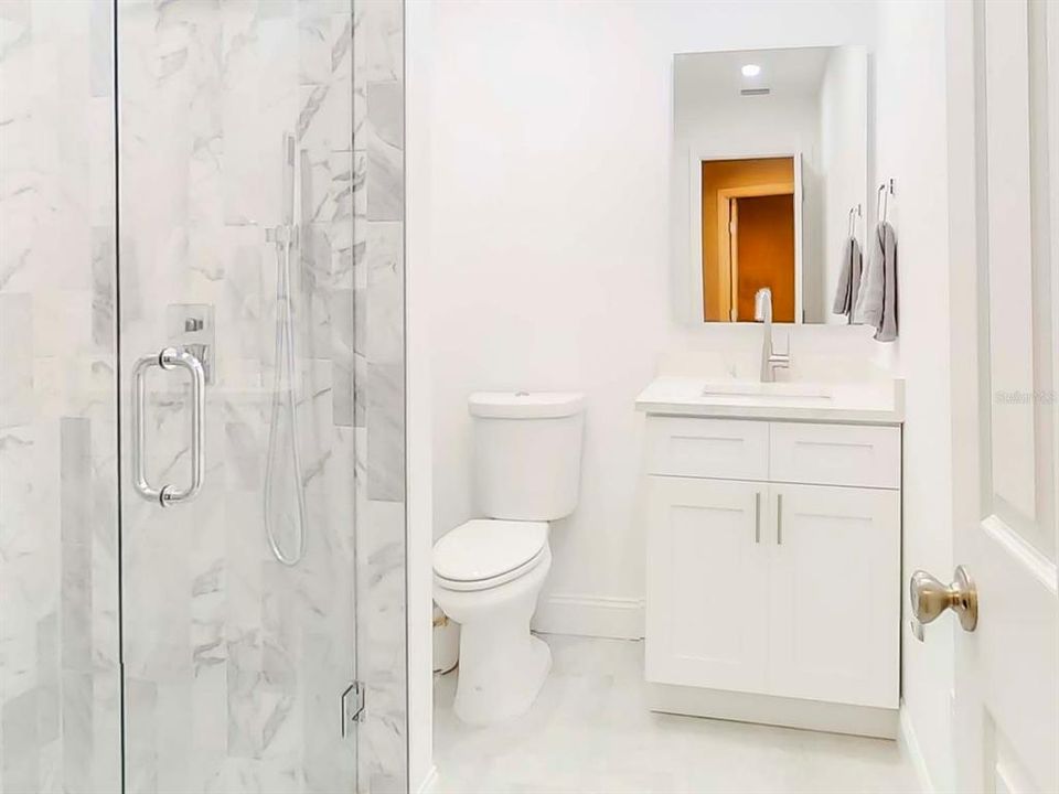 4th Bathroom next to 4th Bedroom. Bathroom was recently remodeled and features a huge walk in shower w/ marble tiles!