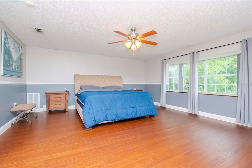 Master Bedroom w/ Lake Views, En-Suite Bathroom, and 2 Walk-In Closets.