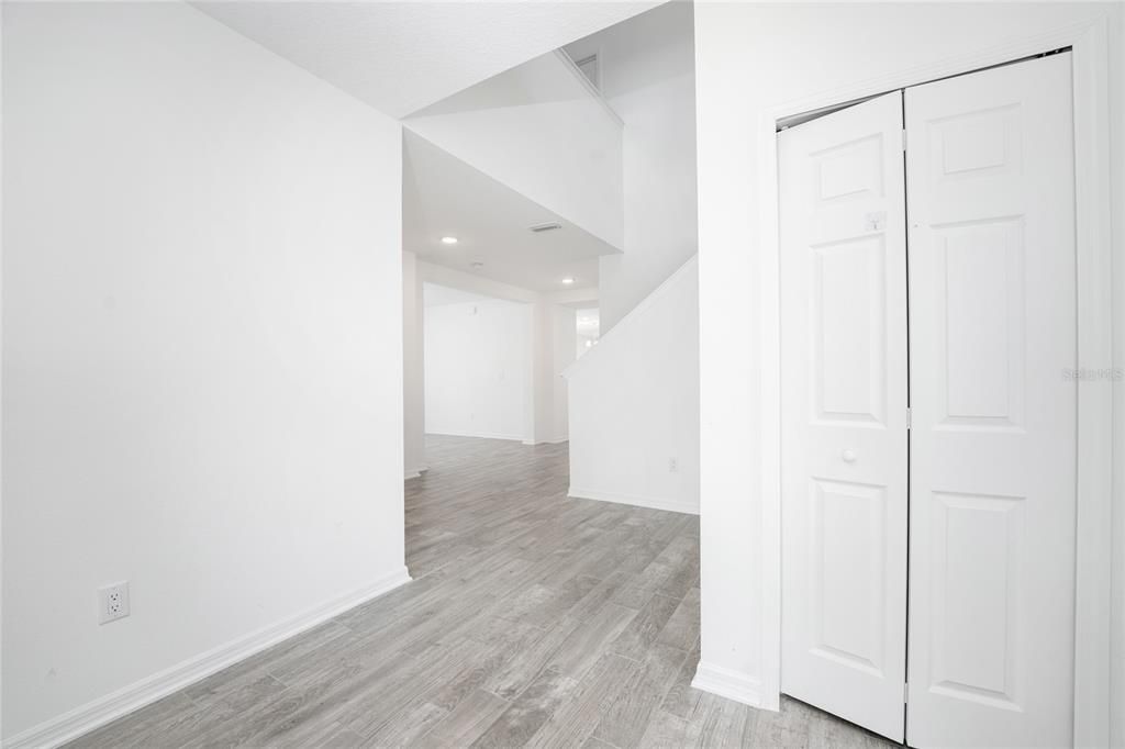 Foyer with extra storage space under the stairs.