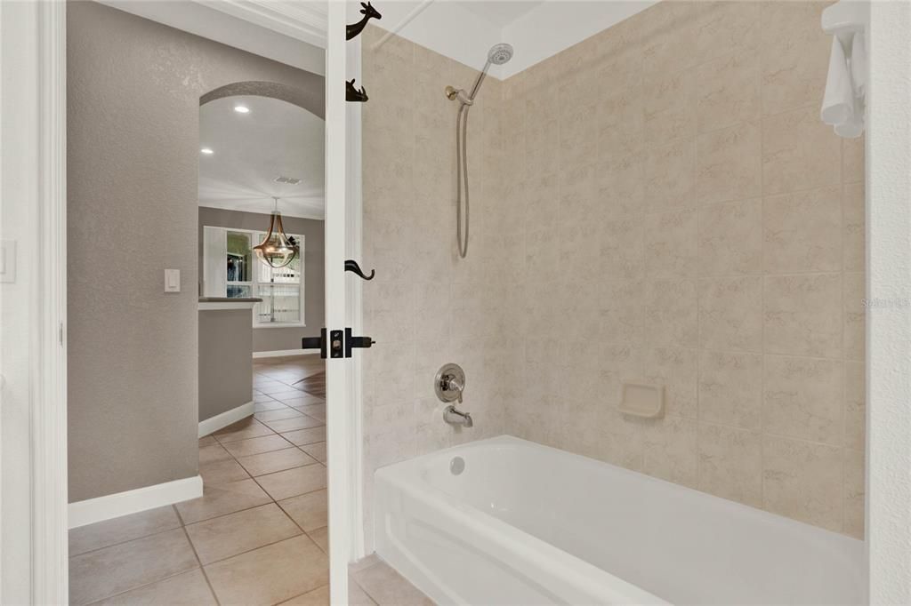 The second full bath, conveniently situated between bedrooms 2 and 3, features a shower/tub combination.