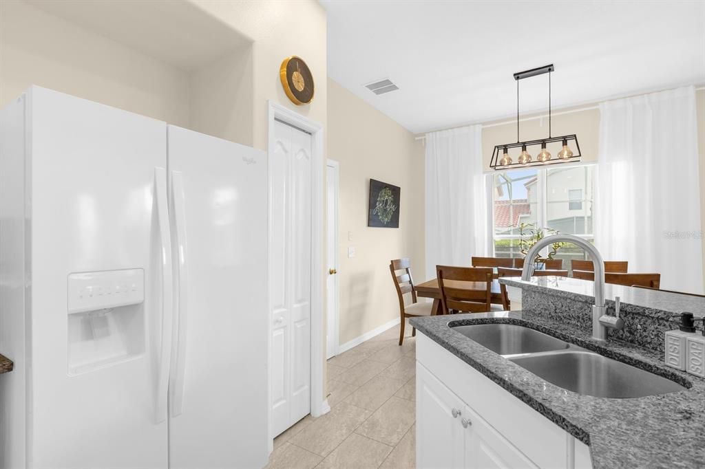 Kitchen Area has white appliances and solid stone counters