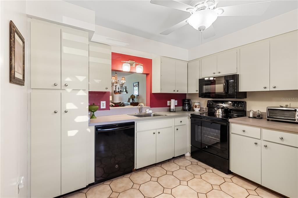 Spacious kitchen featuring ample cabinetry, laundry, and dinette.