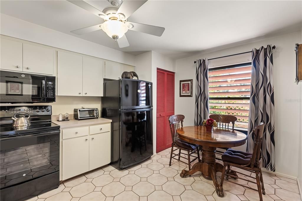 Spacious kitchen featuring ample cabinetry, laundry, and dinette.