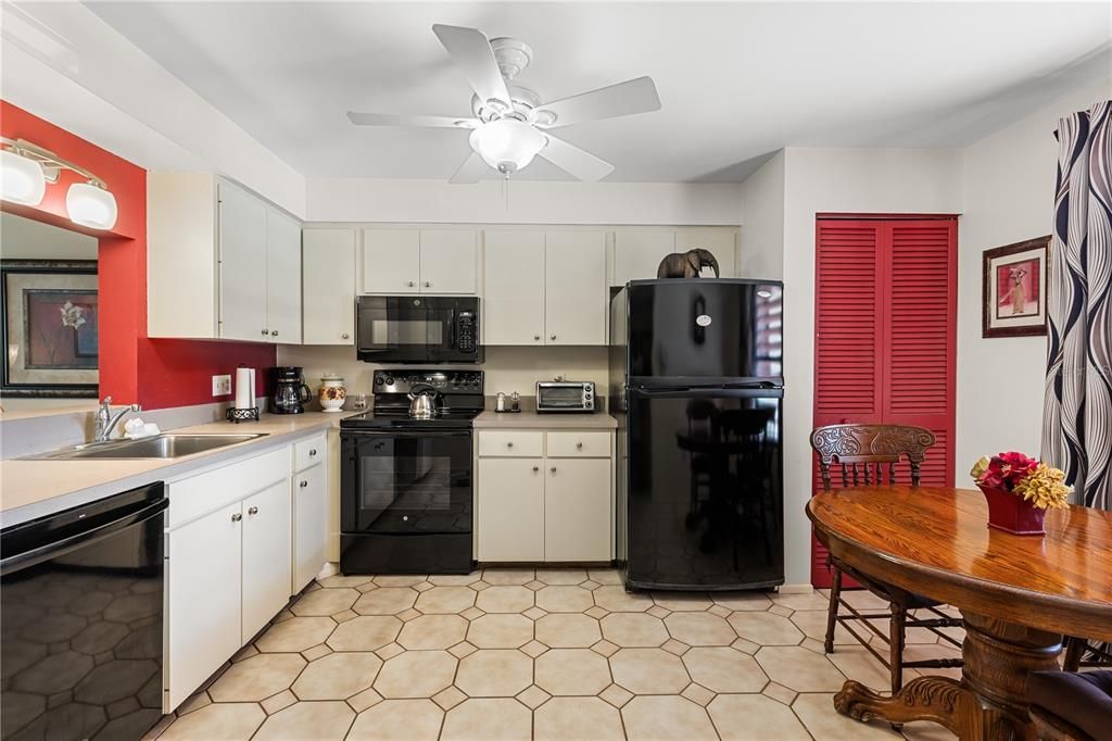 Spacious kitchen featuring ample cabinetry, laundry, and dinette.