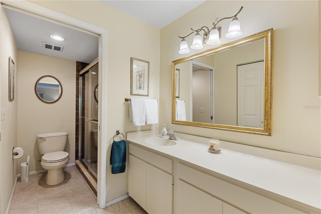 Owners ensuite bathroom featuring a glass enclosed walk-in shower.