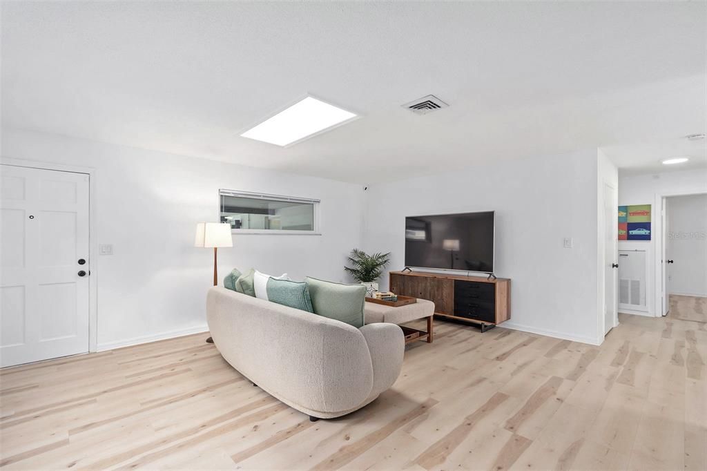 Main residence Living space with fresh interior paint & skylight allowing lots of light