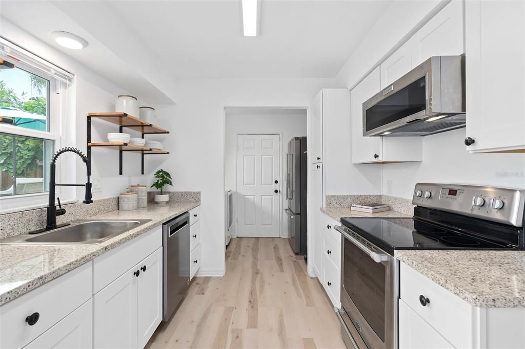 Main residence Kitchen with white shaker cabinets & quartz counters