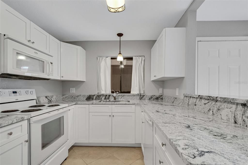 Efficient kitchen layout with large reach-in pantry.