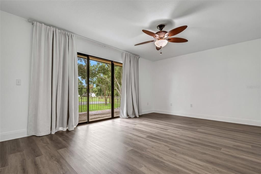 Bedroom #1 has a second floor balcony overlooking the greenbelt and pool and tennis court beyond.