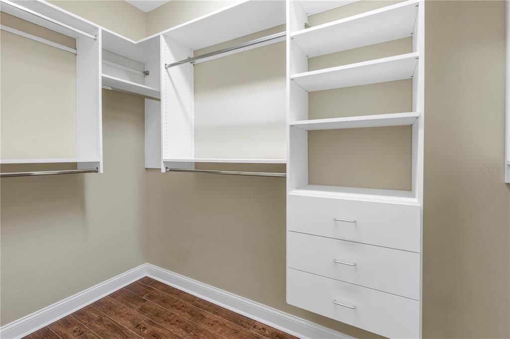 Closet #2 in primary bedroom with built-in shelving