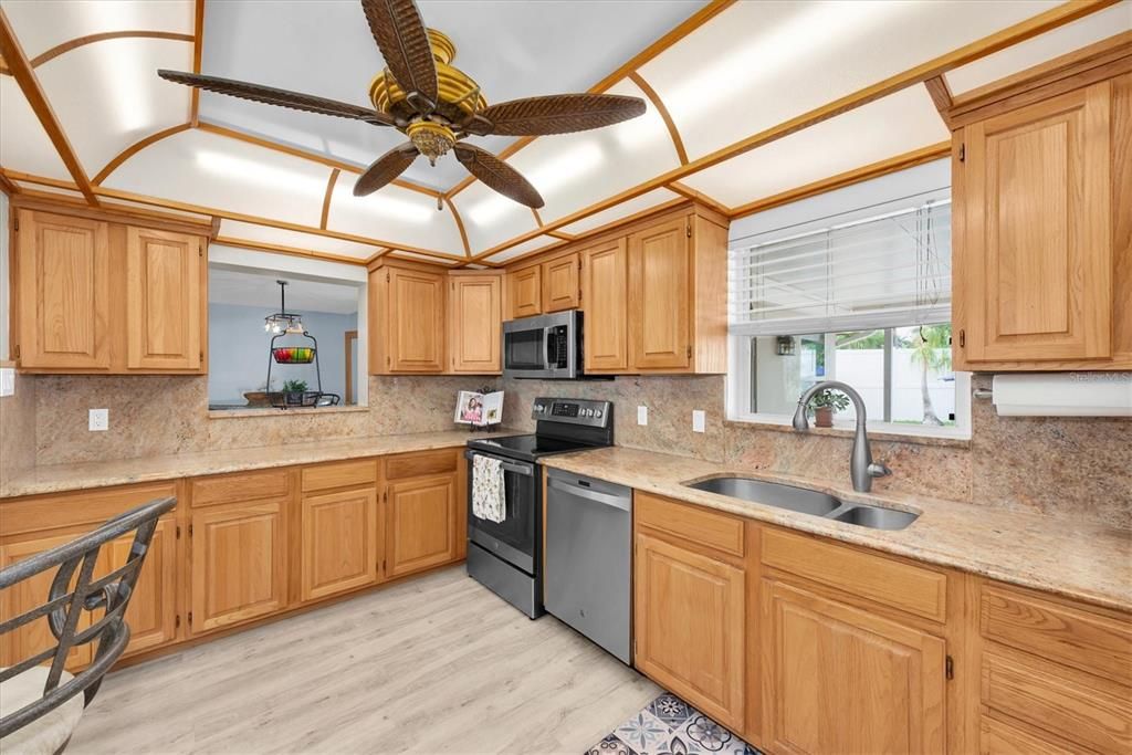 Gorgeous chef's kitchen with window overlooking the pool area