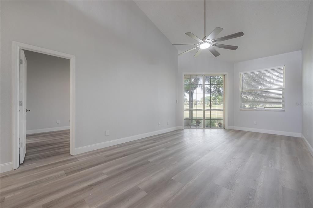 Living Room looking onto screened lanai overlooking golf course