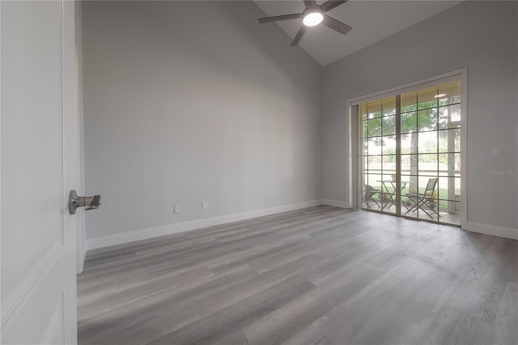 Master bedroom looking onto screened lanai overlooking golf course