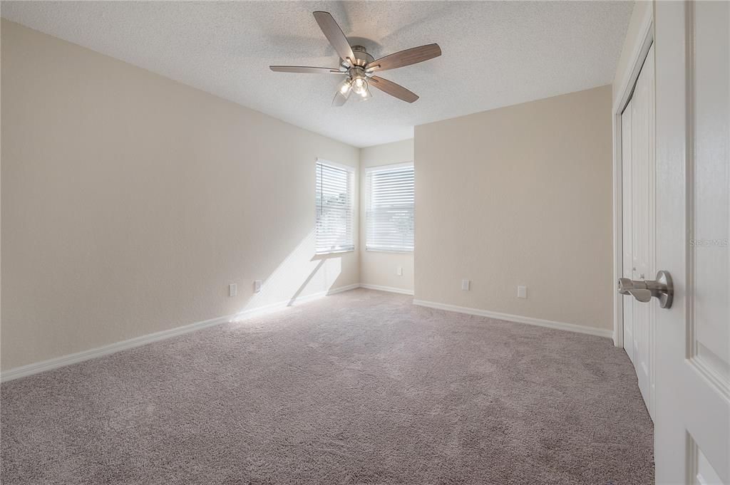 2nd Bedroom.  New carpet and ceiling fan.