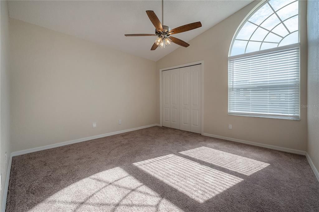 3rd Bedroom (high ceilings).  New carpet and ceiling fan.