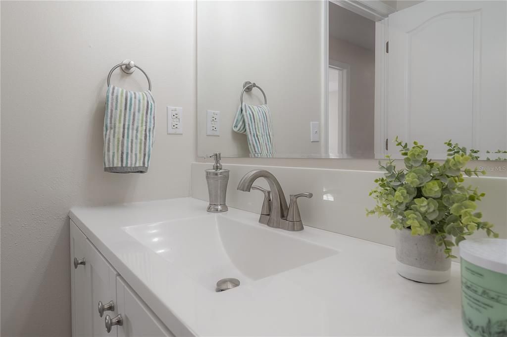 Upstairs full bath with new vanity and mirror.