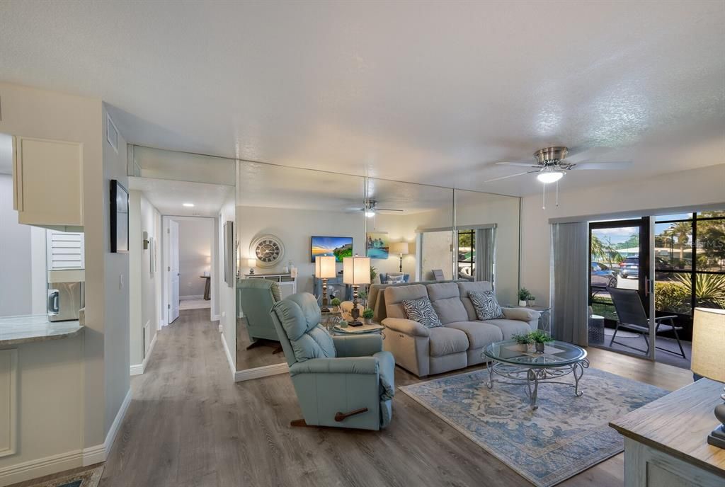 Light and airy living area with sliding doors to your screened lanai and shrub beds