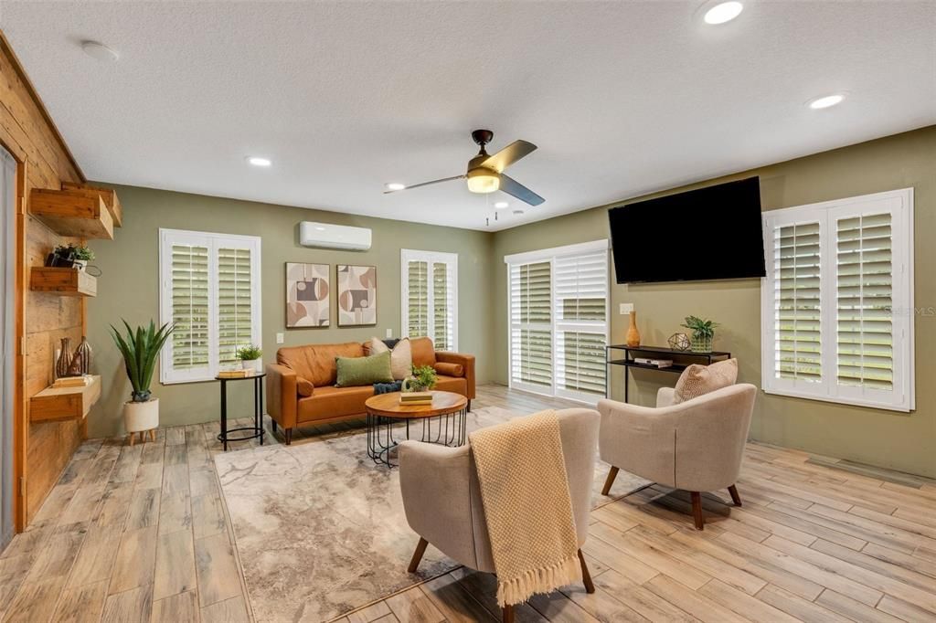 Light & bright family room with slider doors out to back patio~