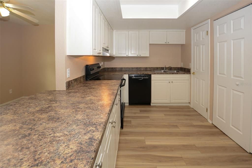 The Kitchen offers plenty of storage. The Washer and Dryer are located behind Bi-Fold doors on the right.