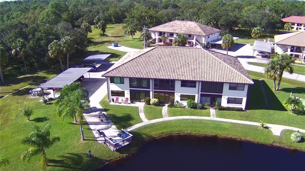 View of building in relationship to the lake. Second building behind.