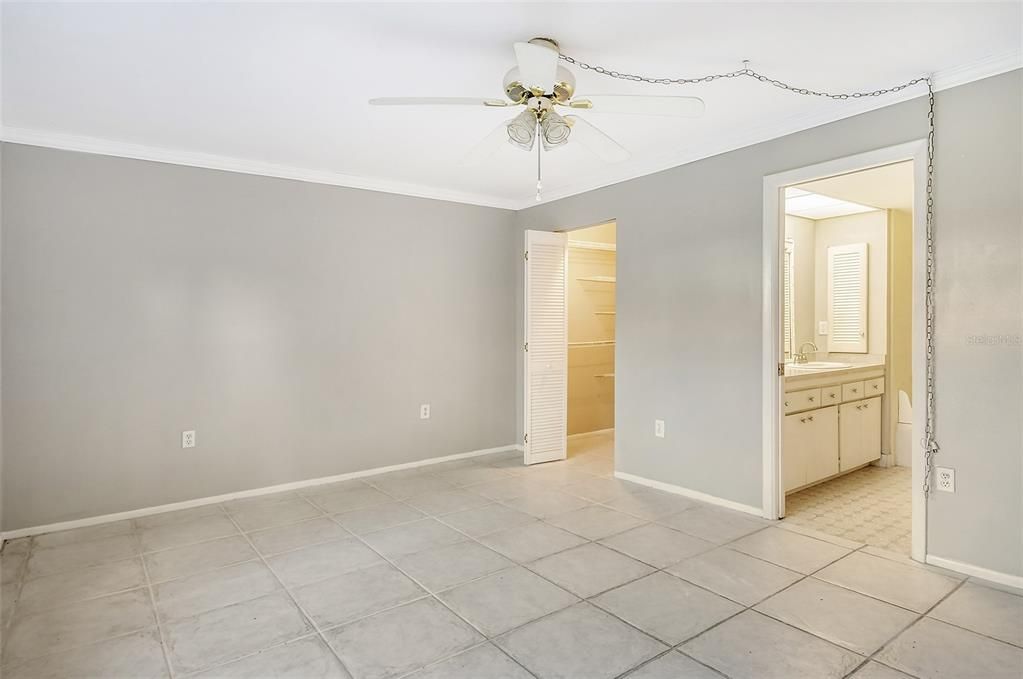 Master bedroom with walk in closet and access to bathroom