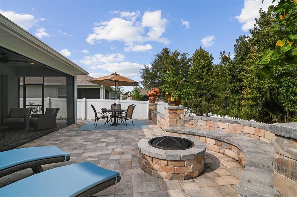 The cherry on top is the amazing backyard where you have your choice of a cozy gathering on the screened lanai or endless entertaining on the extensive paver patio, FIREPIT included as well as hot tub hookup, a vinyl privacy fence and WOODED VIEWS!