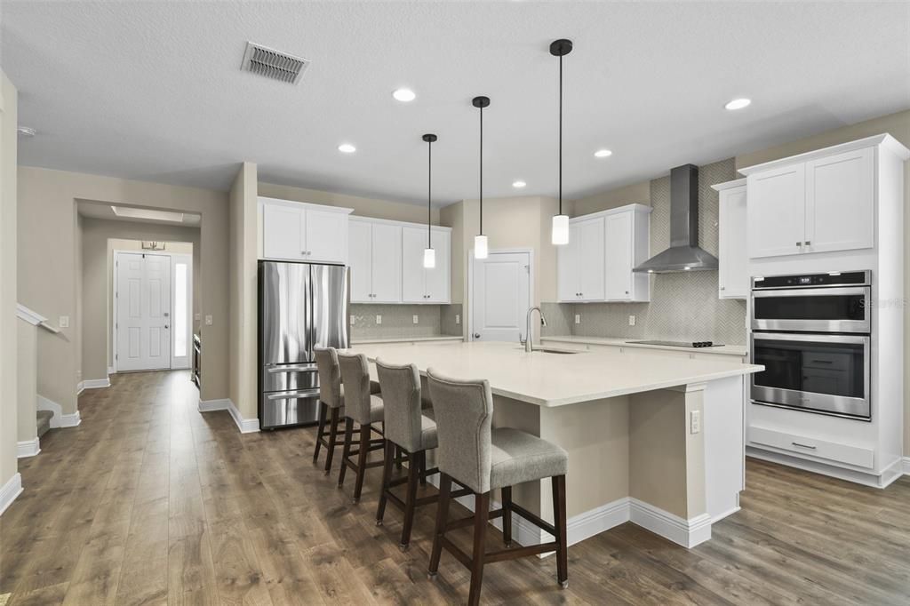 Better than a new build, this light and bright OPEN CONCEPT has UPGRADES throughout, WOOD LAMINATE FLOORS in the main living areas, high ceilings and you will fall in love with the designer accent walls in the formal dining and primary bedroom.