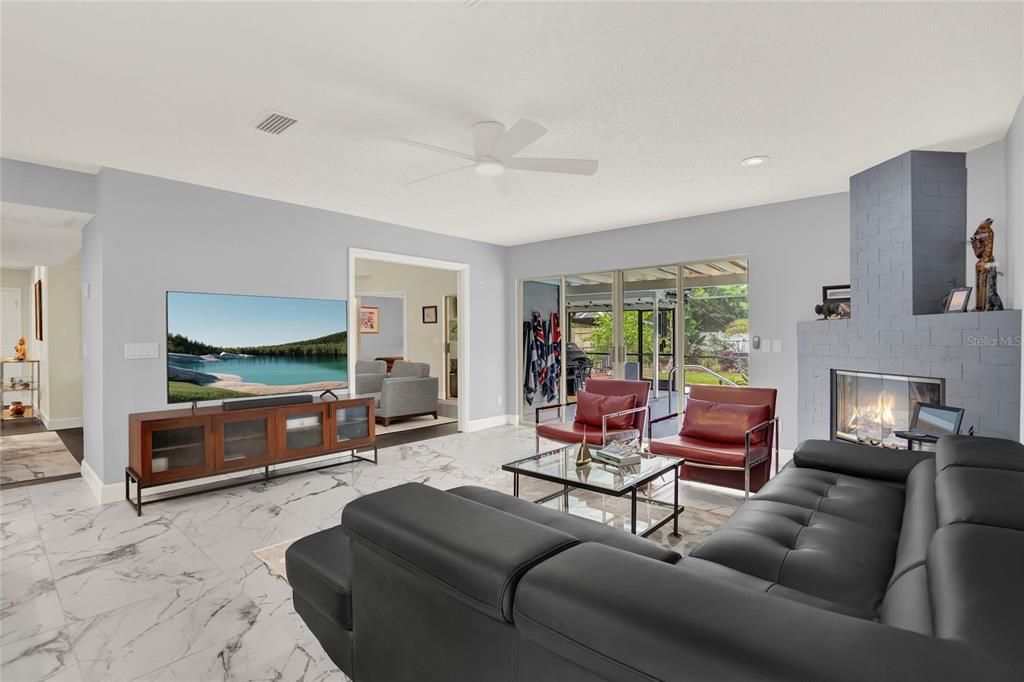 Family Room with Fireplace and Slider to screened patio and pool