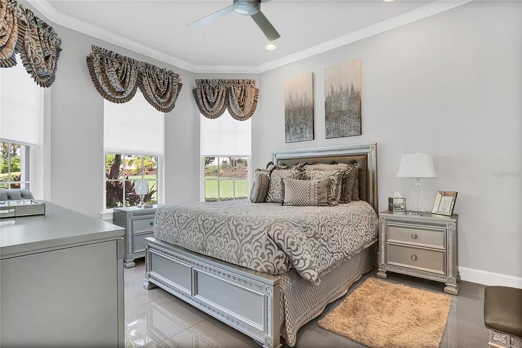 Bedroom #2, bay window, designer fan, crown molding, consistent glamorous flooring throughout.