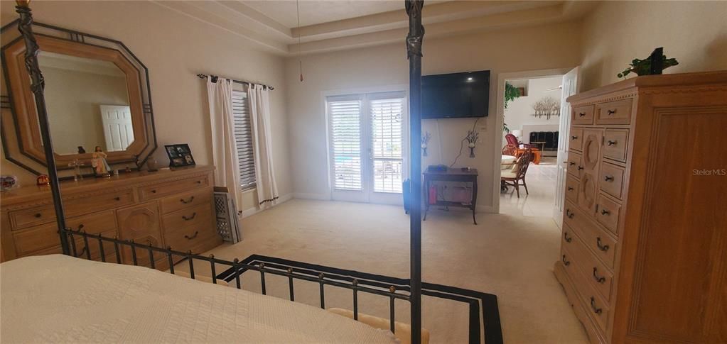 The over sized Master suite has tray ceilings, private access to the pool, 2 walk in closets with custom shelfing, ensuite full bathroom with double sinks, separate tub and shower