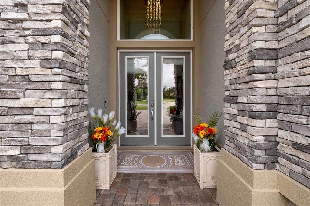 Front Doors to Foyer w/Chandelier & High Ceiling