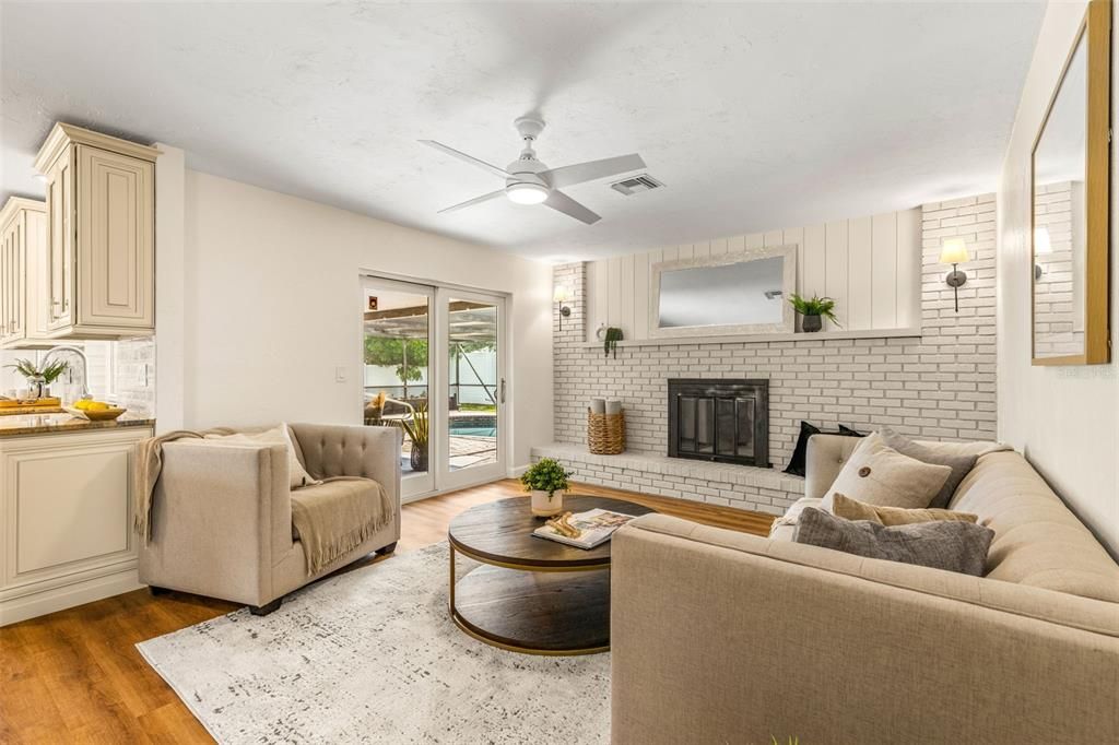 Family room with brick fireplace wall