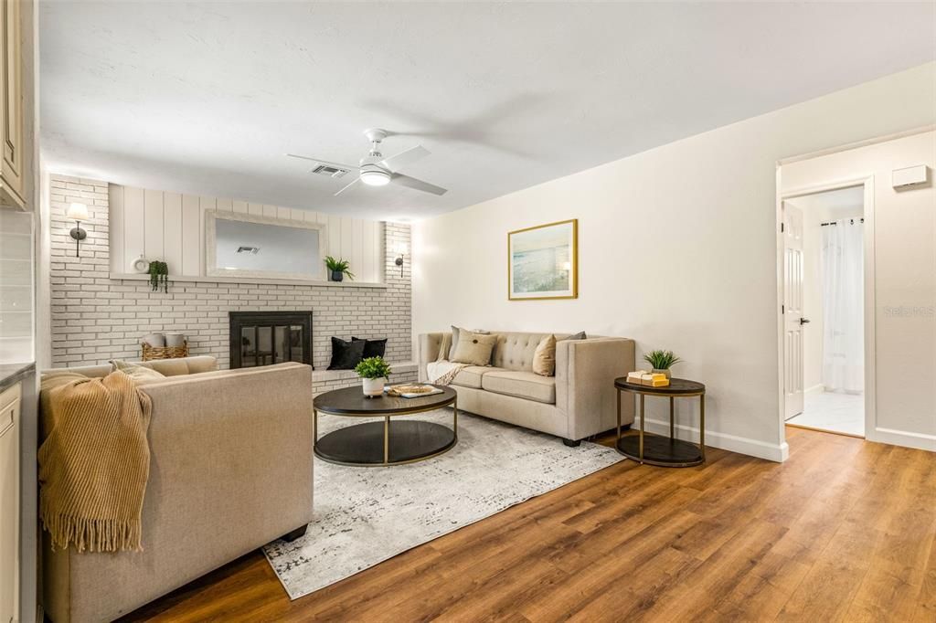 Family room with brick fireplace wall