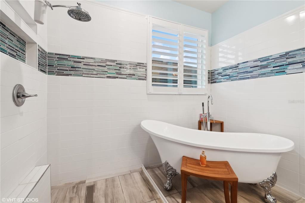 Renovated handicapped accessible primary bath with clawfoot tub