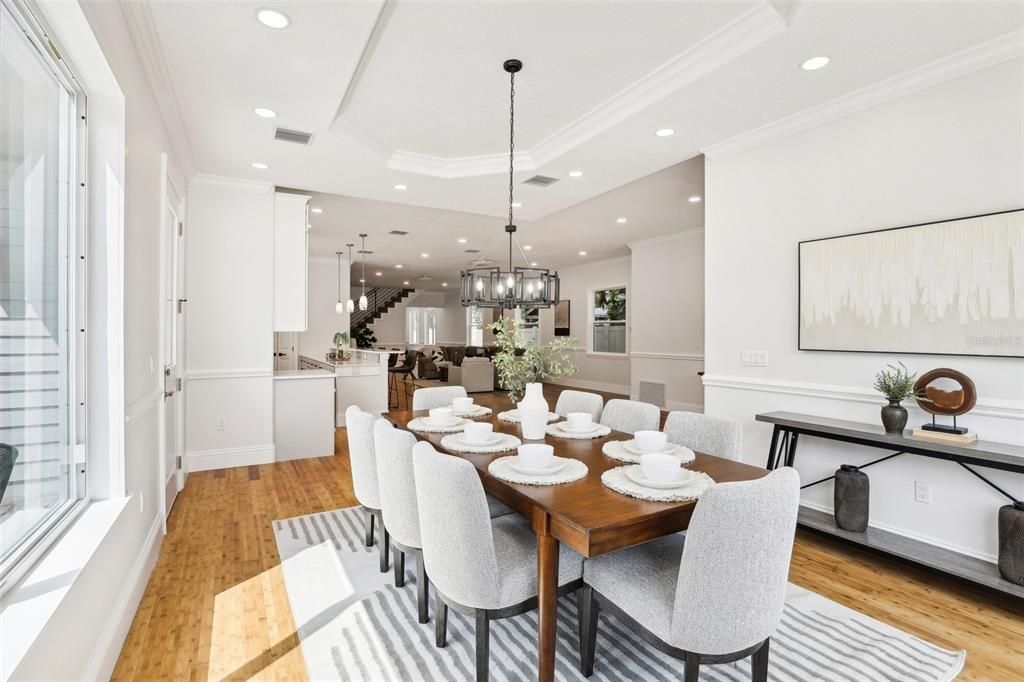 Situated just off the main living and kitchen, the dining room offers access to side patio to the left and a beverage bar with bar refrigerator between dining and kitchen for ease in entertaining both formal & informal gatherings.