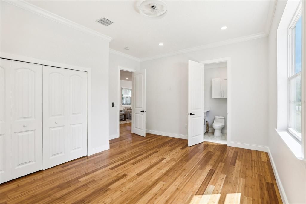 Another view of secondary master/in-law suite with view to ensuite bath & main living. Double closet wall offers built-in custom shelving.