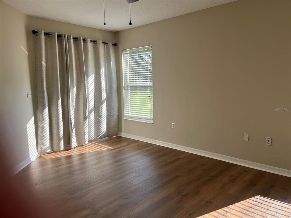 PIMARY BEDROOM WITH SLIDING DOORS TO COVERED PATIO