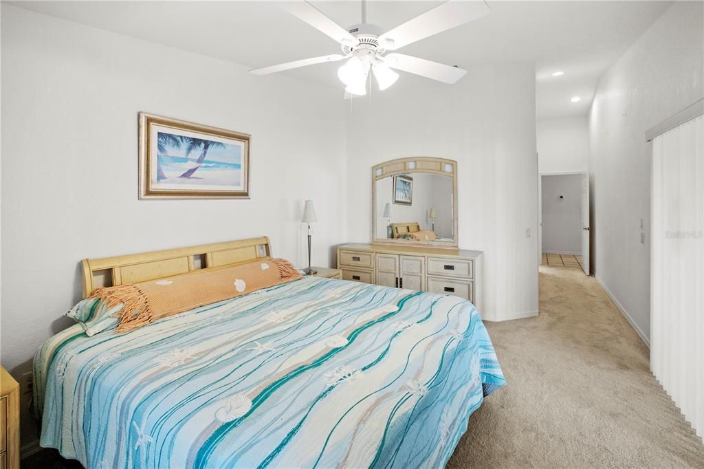 Spacious 12' x 16' Primary Bedroom with Gorgeous Lake Views and Sliders out to the Relaxing Lanai