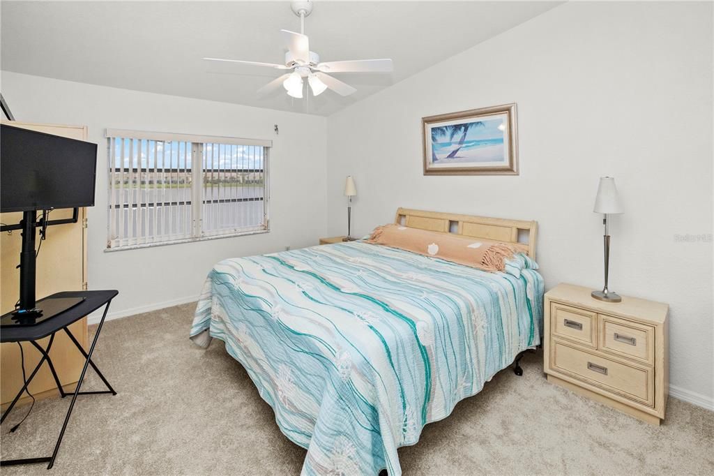 Spacious 12' x 16' Primary Bedroom with Gorgeous Lake Views and Sliders out to the Relaxing Lanai