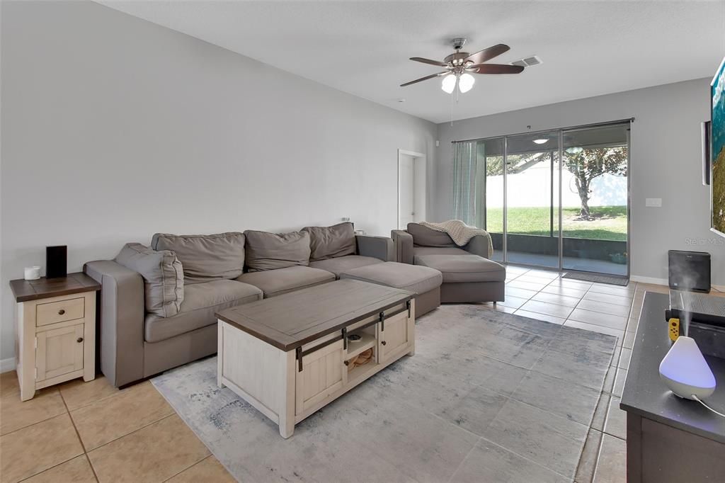 Great room with sliders leading to the trussed back porch.